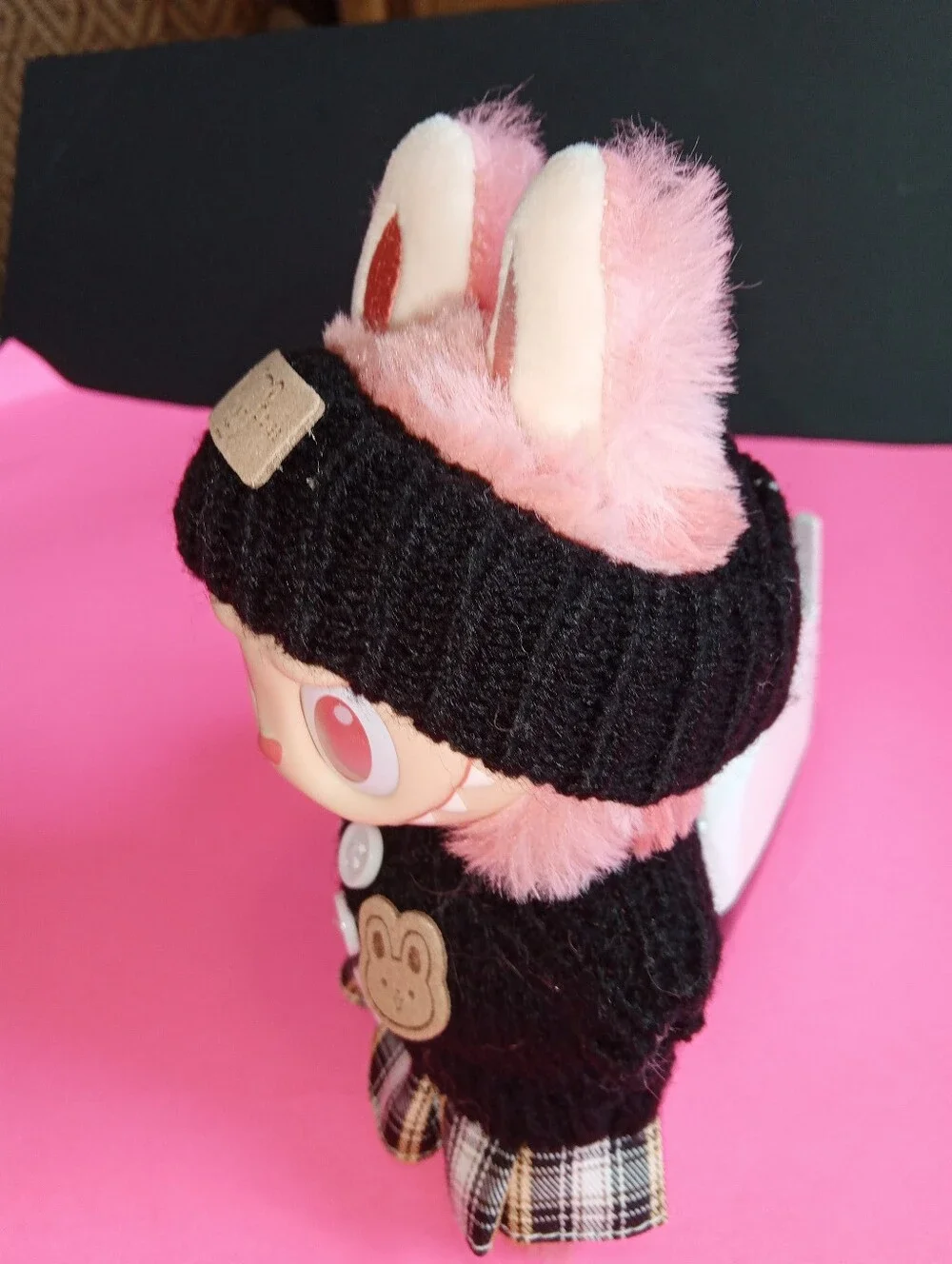 Labibu Doll outfit. Wearing A Knit Striped Sweater, Plaid Skirt, And Headband.